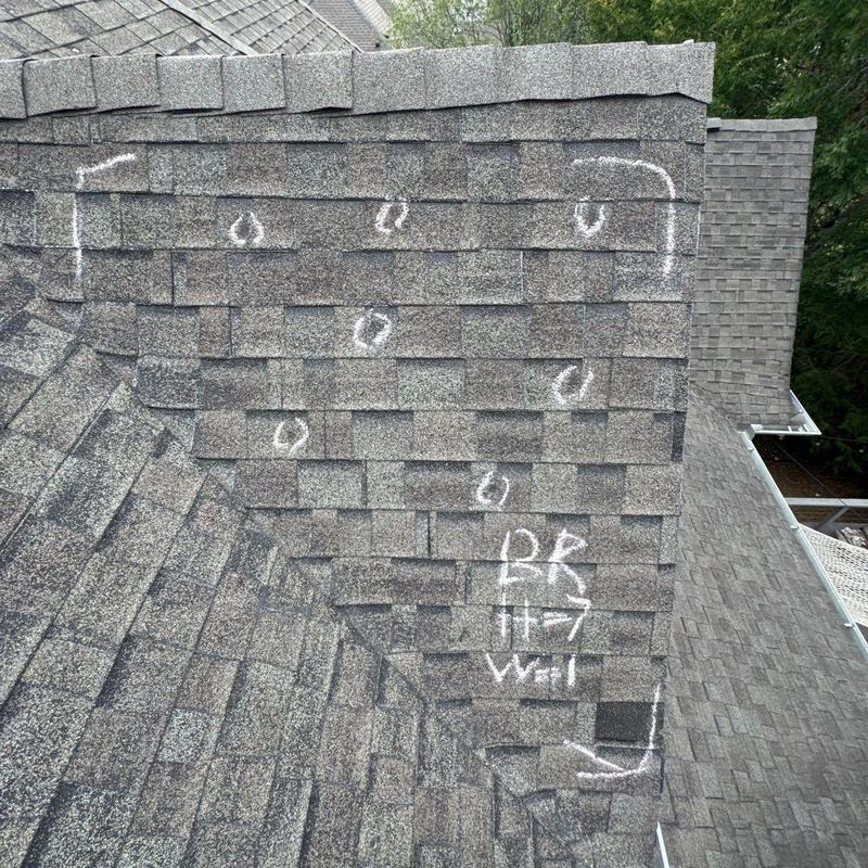 Roof shingles marked for hail damage inspection