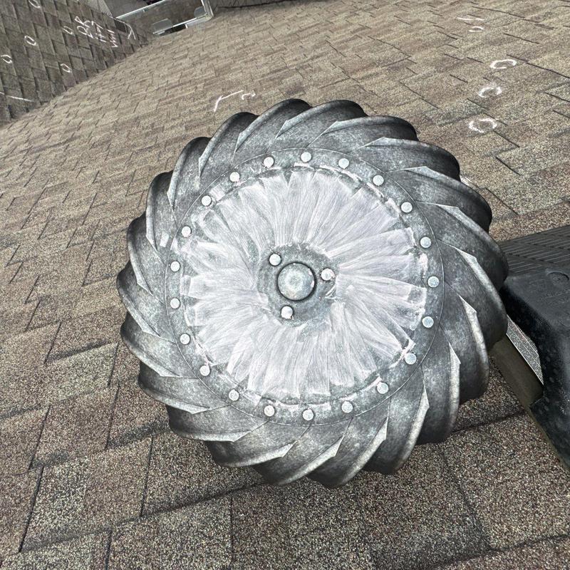 Roof turbine vent with wear marks on shingles