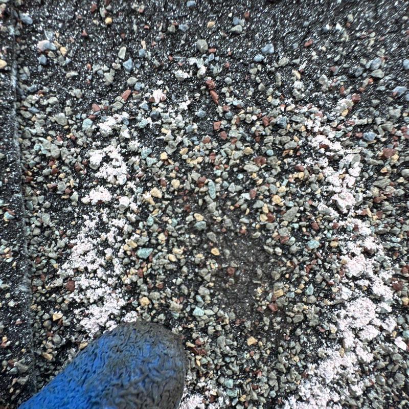 Shingle granule loss indicating hail damage on roof shingles