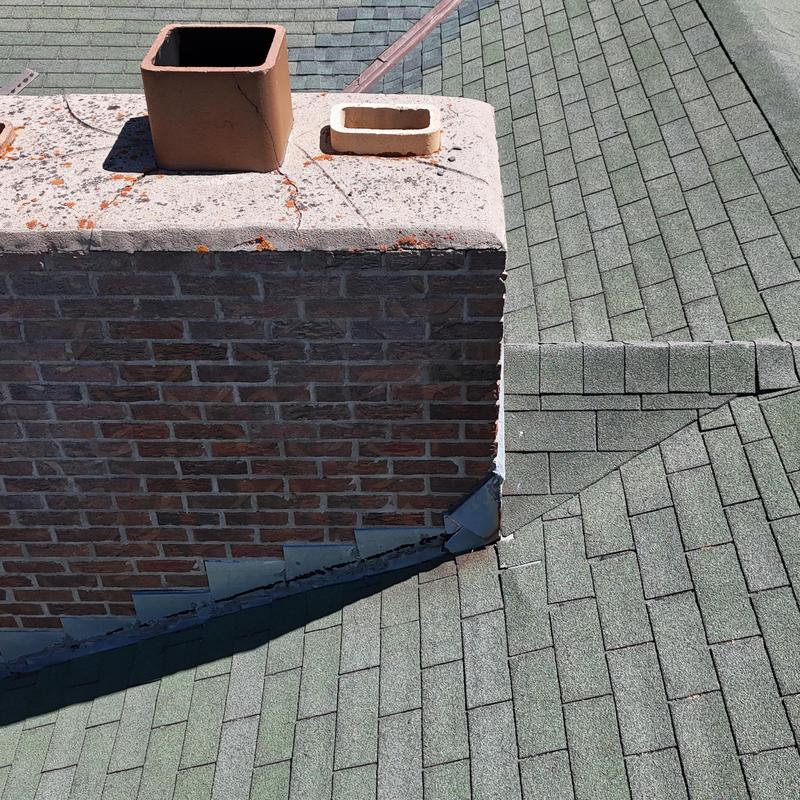 Asphalt shingle roof with brick chimney and flashing