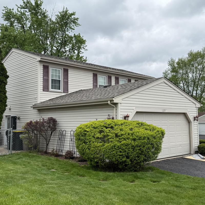 Asphalt shingle roof and clean gutters on house