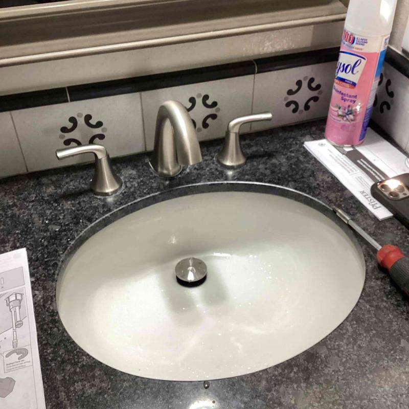 Bathroom faucet and sink installation on granite countertop