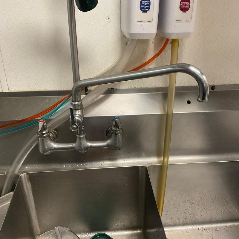 Kitchen faucet with discolored water flow and plumbing lines