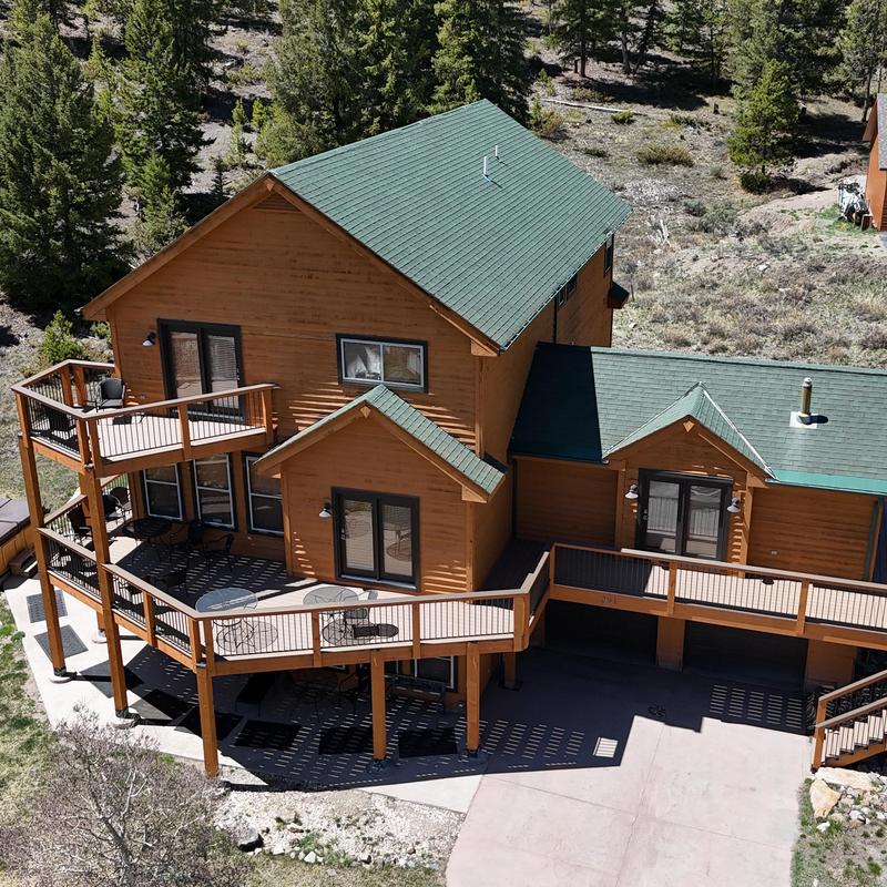 Green asphalt shingle roof and gutter system on cabin