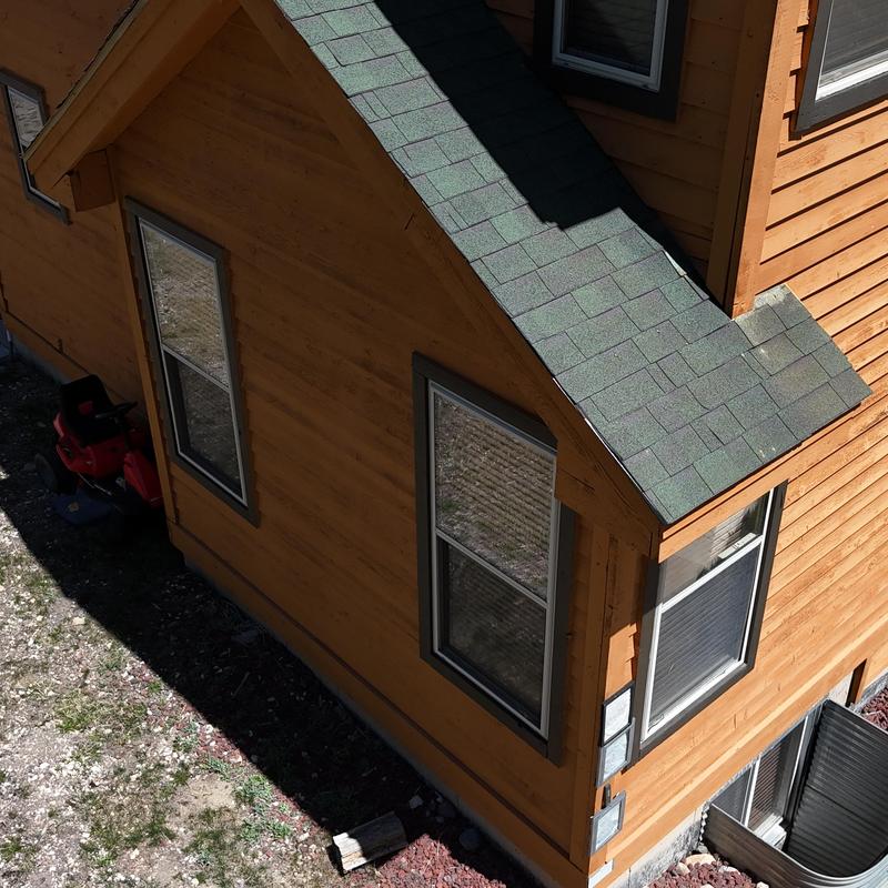 Green asphalt shingles on wood residential roof