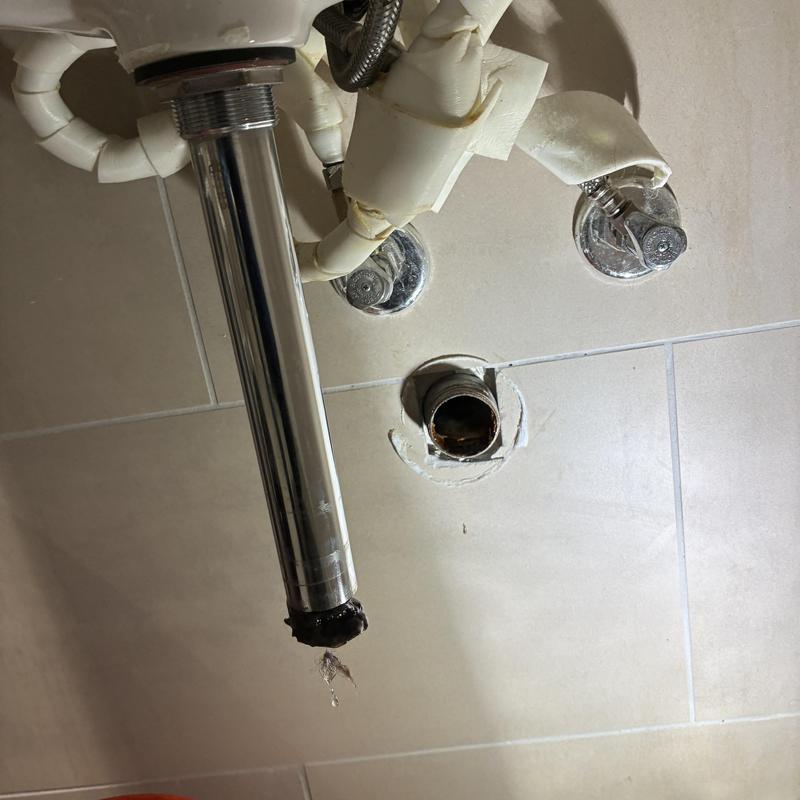 Bathroom sink drain pipe leaking with exposed connections