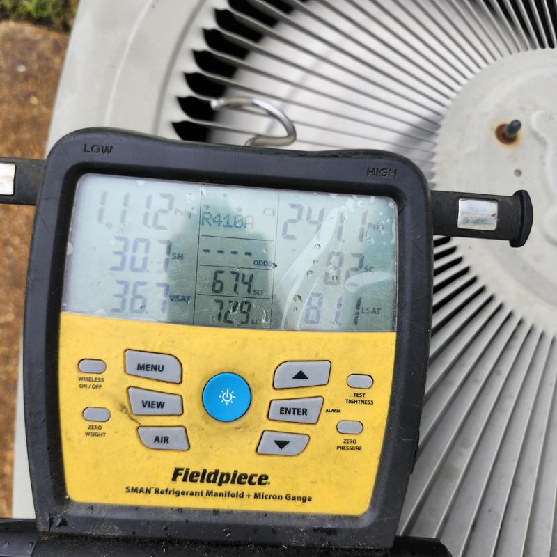 Refrigerant manifold gauge measuring pressures on condenser coil Refrigerant manifold gauge measuring pressures on condenser coil