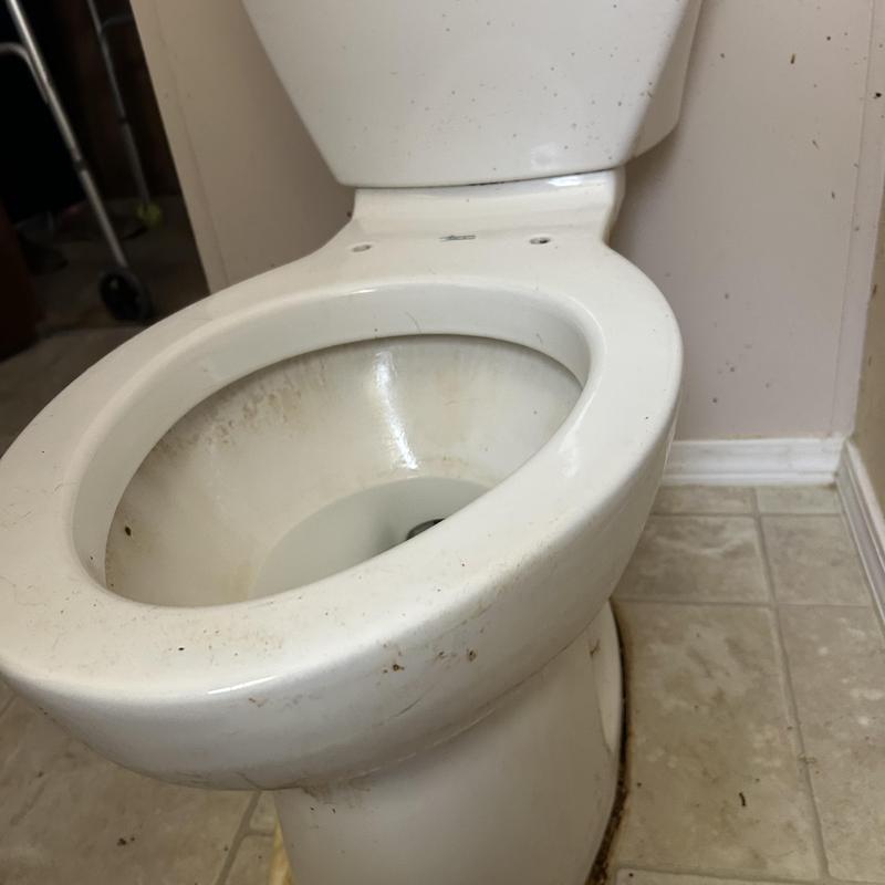 Toilet bowl with leak repair in progress