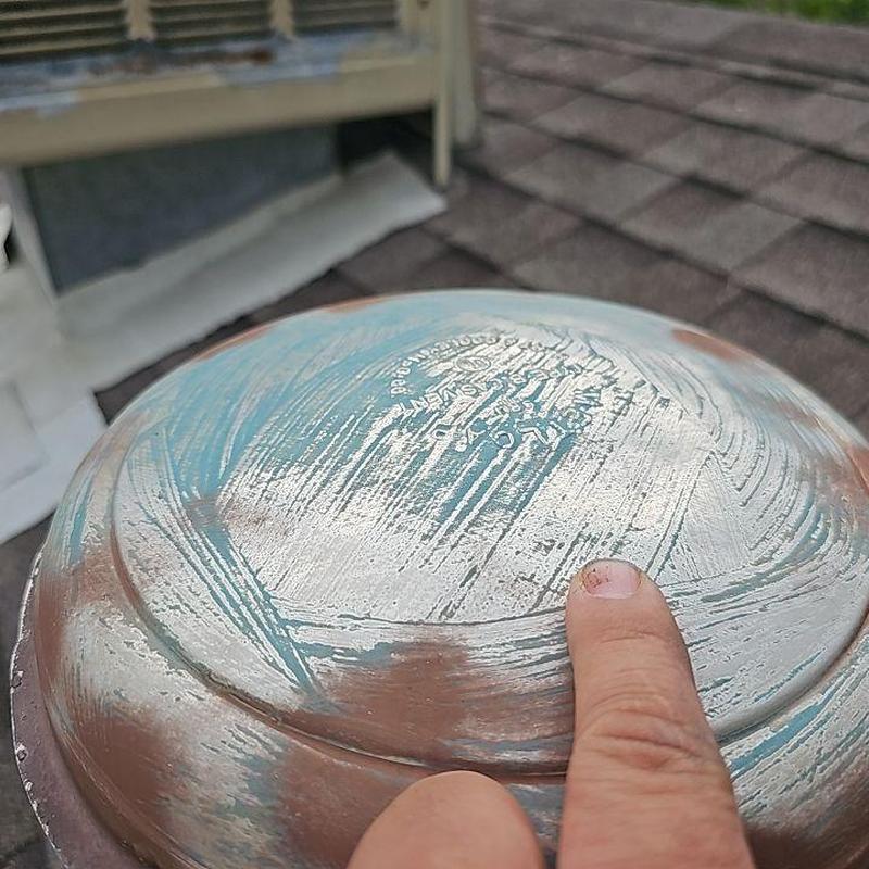 Metal roof vent with hail damage and scraped paint Metal roof vent with hail damage and scraped paint