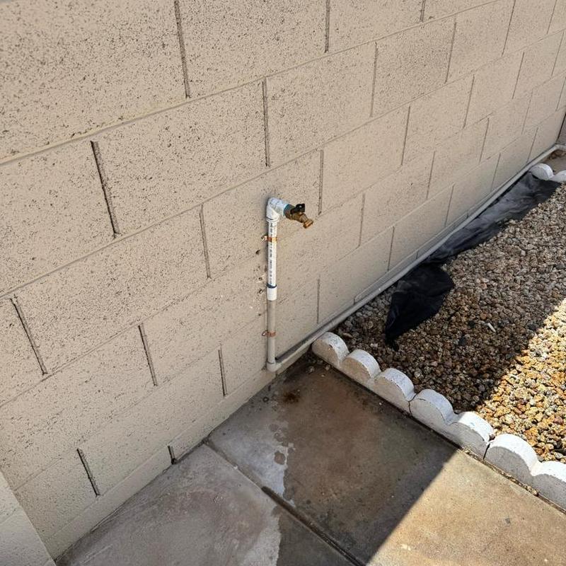 12 PVC pipe and hose bib with copper straps on wall