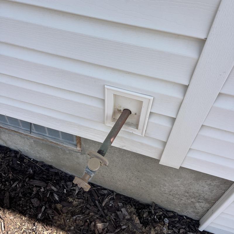 Hose bib installation on exterior house wall