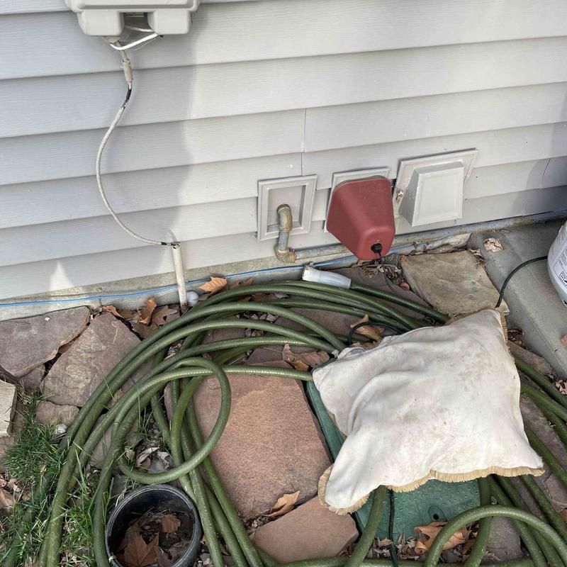 Gas line exterior wall penetration with hose and cushion