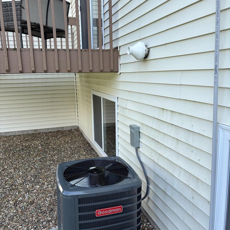 Goodman air conditioner unit installed outside house