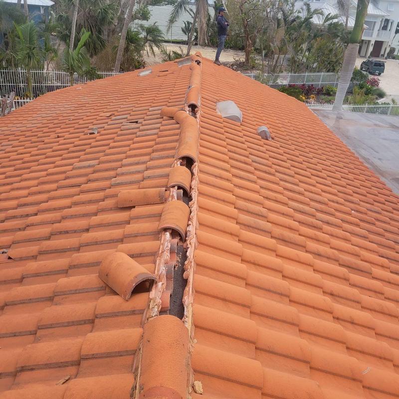 Concrete tile roof ridge with broken tiles removed