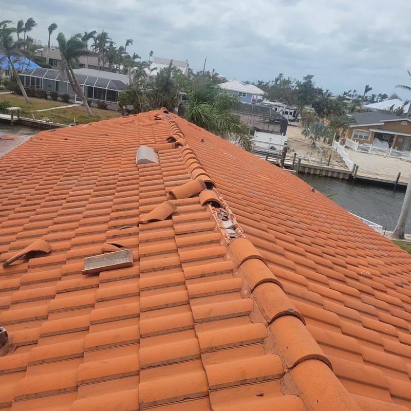 Concrete tile roof with cracked and displaced tiles