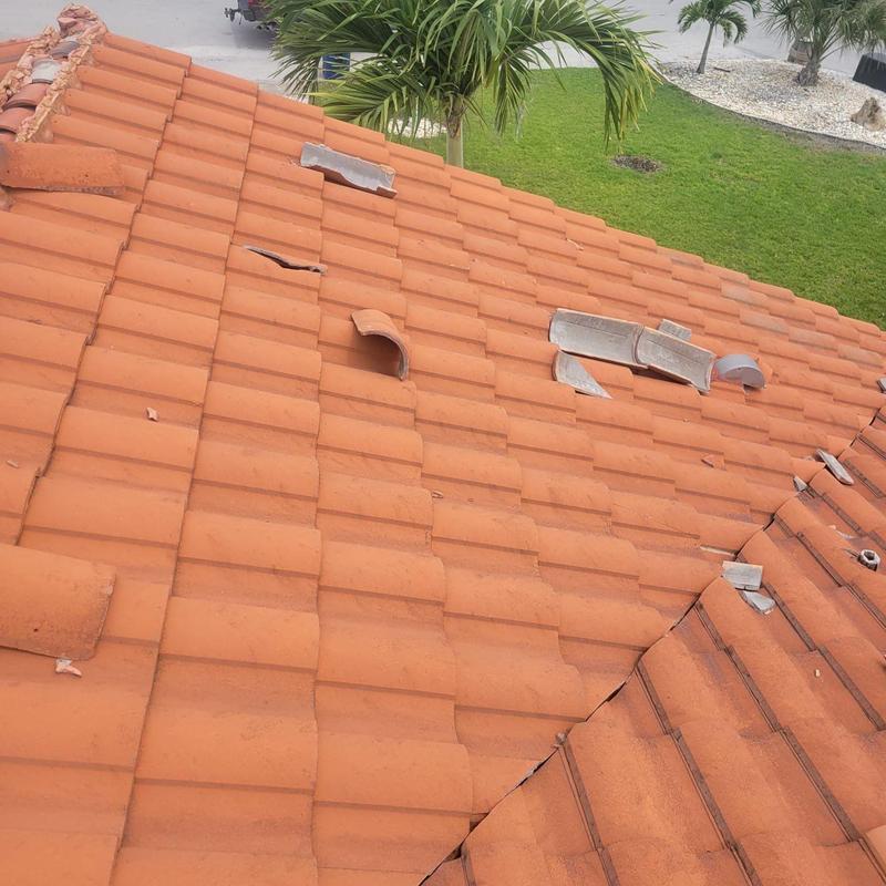 Concrete tile roof with cracked and broken tiles