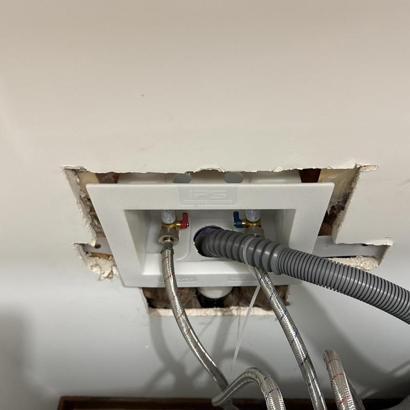 Washing machine box with water valves and drain hose