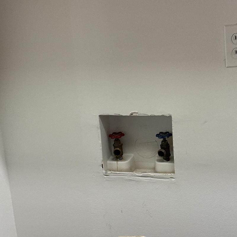 Washing machine box with hot and cold valves