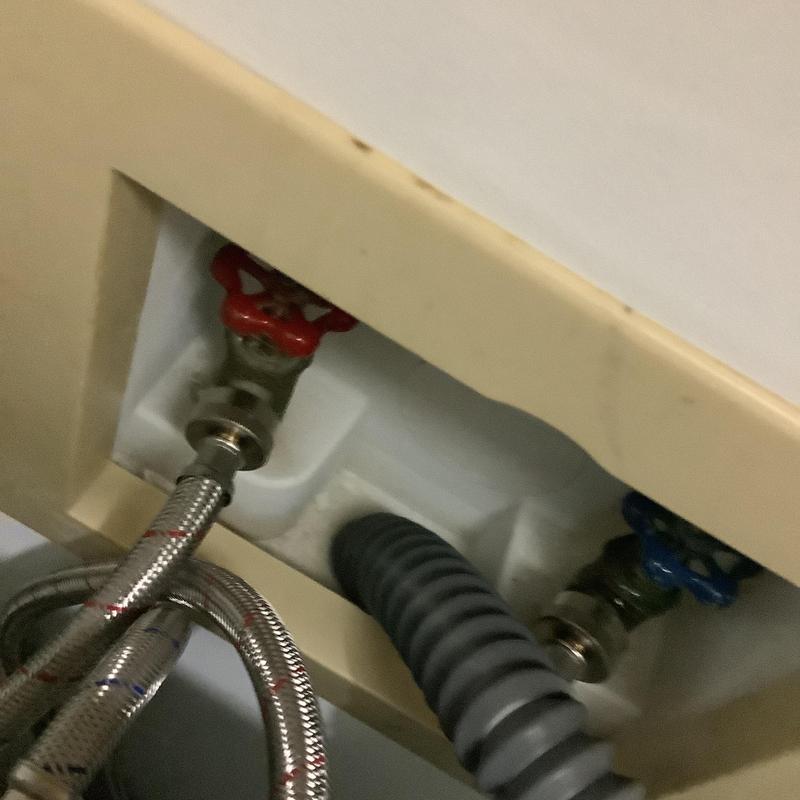 Washing machine box with inlet valves and drain hose