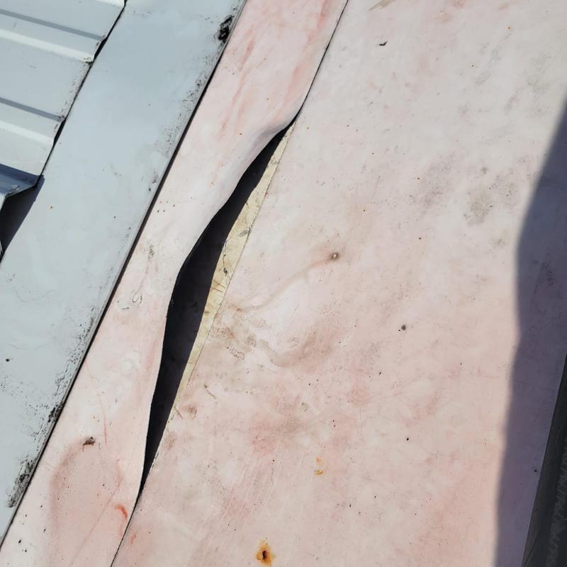 TPO roofing membrane loose seam gap on metal roof junction