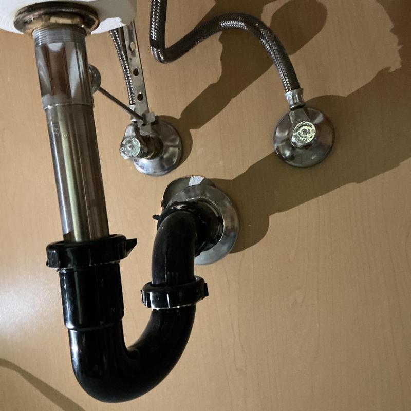 Toilet drain trap and laundry valve connections under sink Toilet drain trap and laundry valve connections under sink