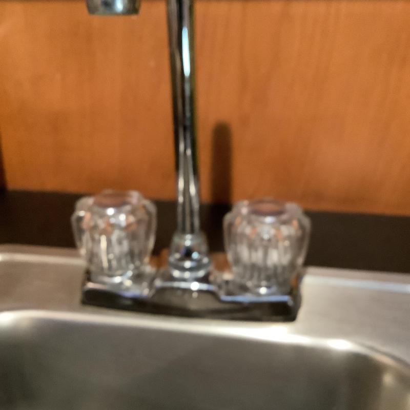 Bar sink faucet with clear handles over stainless steel sink