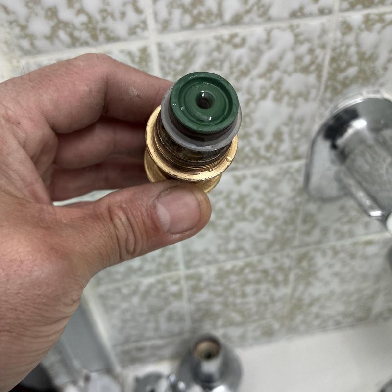 Shower faucet diverter assembly held in hand for repair
