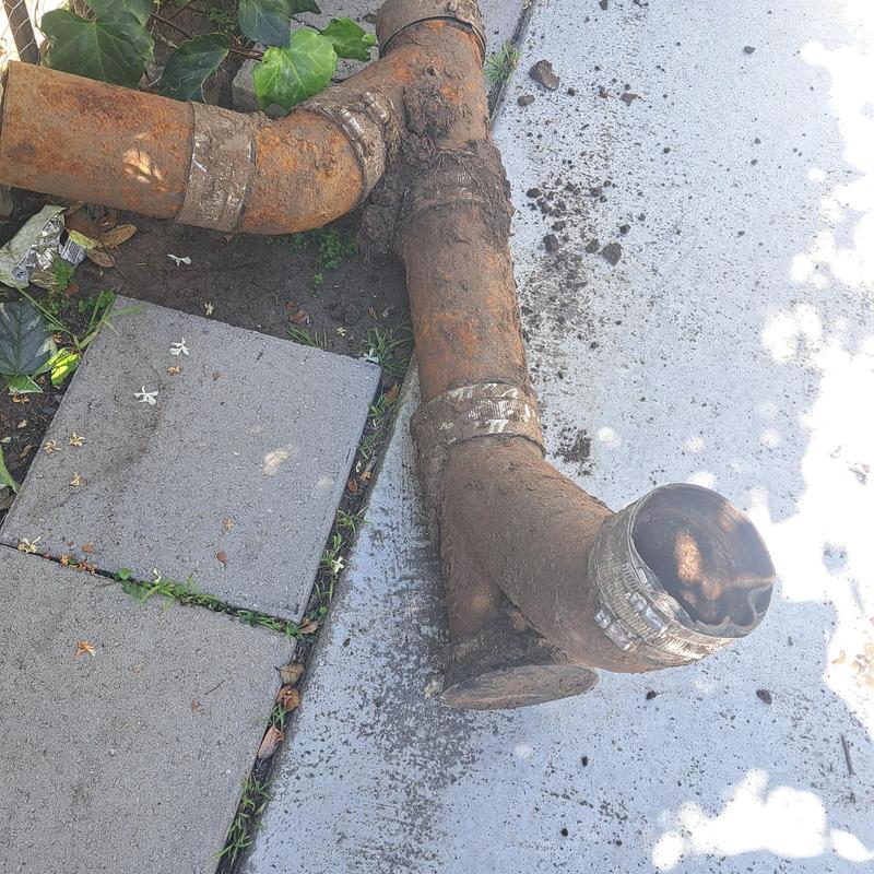 Cast iron sewer pipe section removed on concrete slab