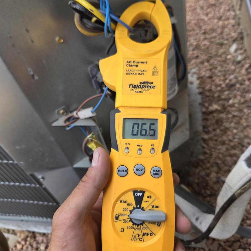 AC current clamp meter showing electrical reading