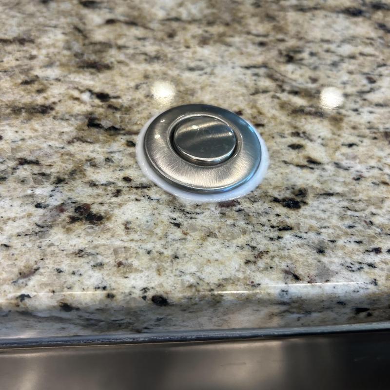 Kitchen sink faucet button sealed to prevent leaks