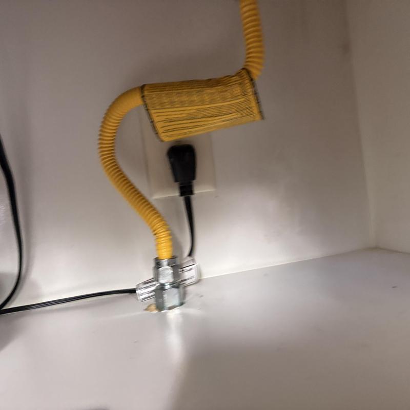 Flexible gas line with leak repair behind stove