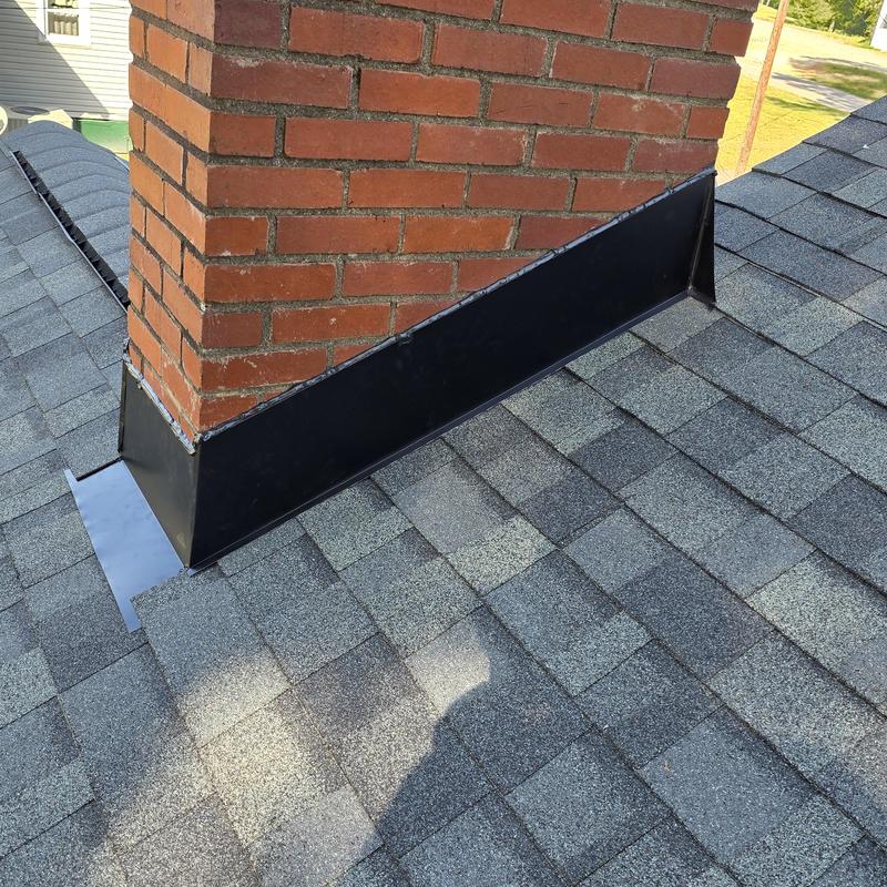 Chimney flashing with Owens Corning gray shingles Chimney flashing with Owens Corning gray shingles