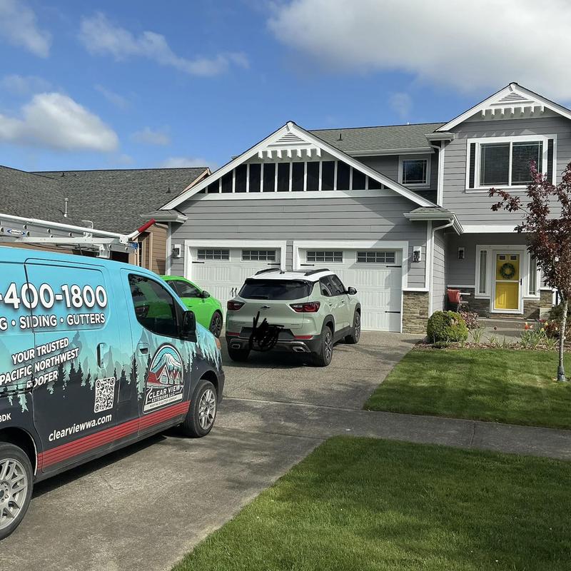 Roof shingles inspection with service van and driveway