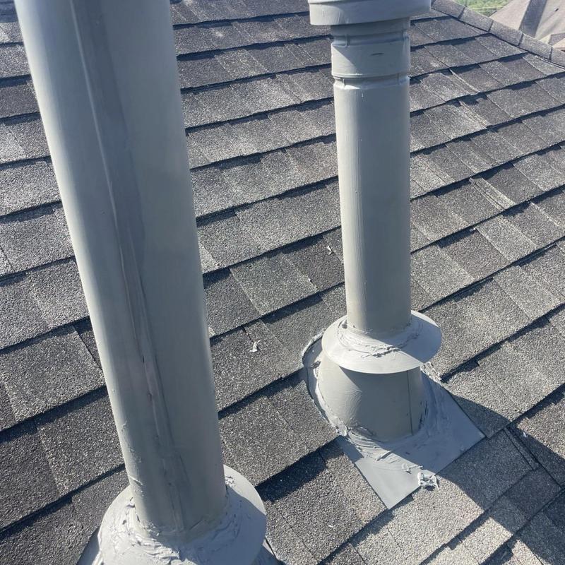 Plumbing vent pipes with sealed flashing on roof shingles Plumbing vent pipes with sealed flashing on roof shingles