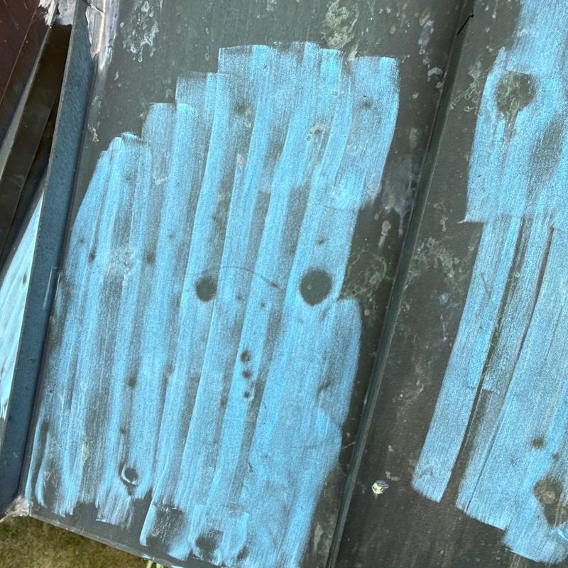 Metal roofing panel with hail damage markings