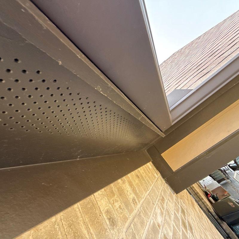 Metal soffit and fascia installation on brick wall