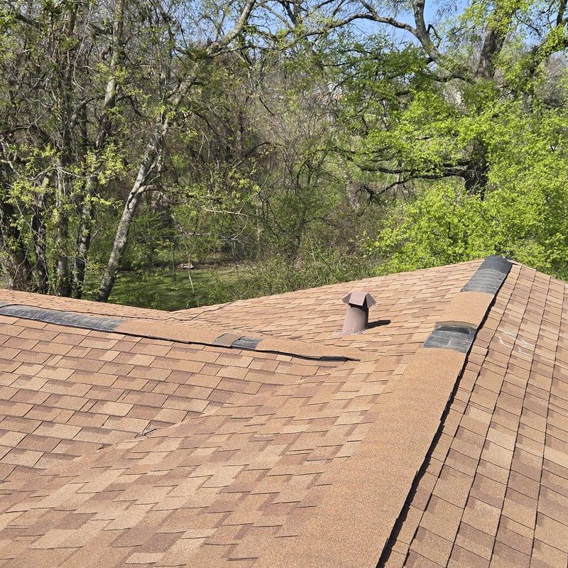 Asphalt shingle roof with hail damage and repairs