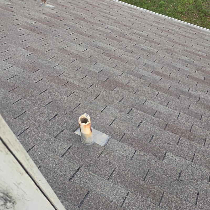 Roof vent flashing on shingle roof after hail damage