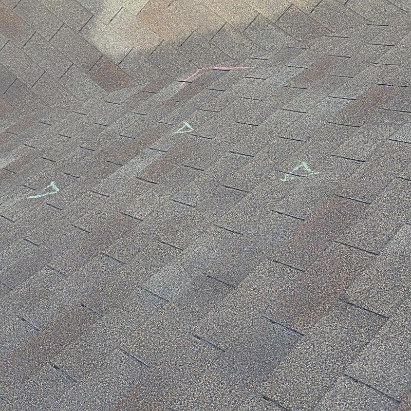 Asphalt roof shingles with hail damage markings