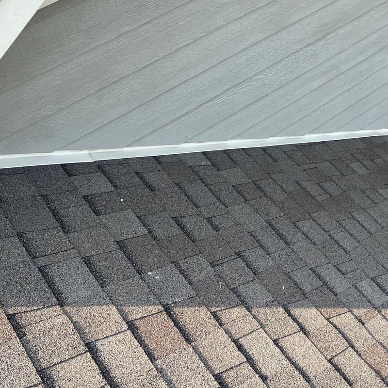 Asphalt shingles with hail damage near flashing trim