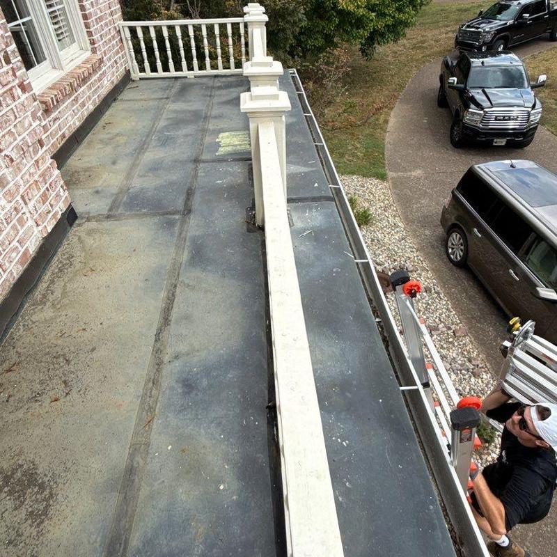 Flat metal roof surface inspection and railing detail