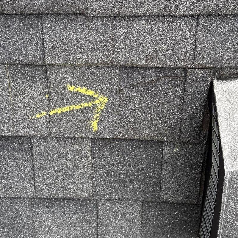 Asphalt roof shingles with marked hail damage