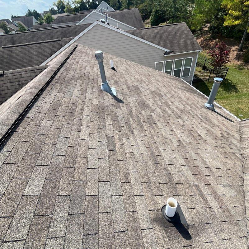 Asphalt shingle roof with vent pipes and no visible damage