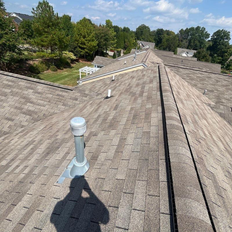 Asphalt shingle roof with ventilation pipes on residential home