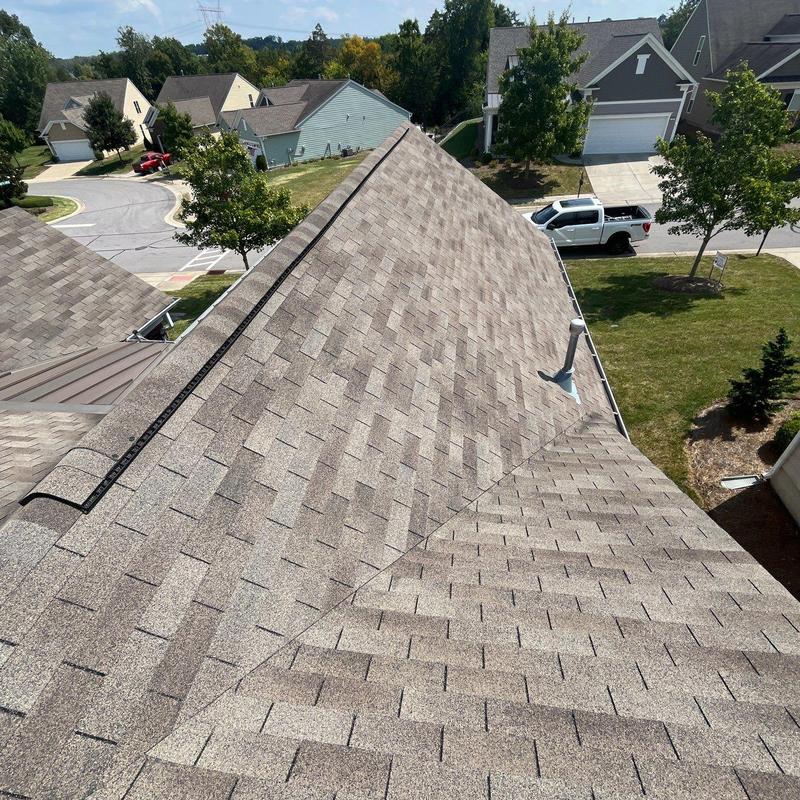 Asphalt shingle roof with ridge vent in residential area