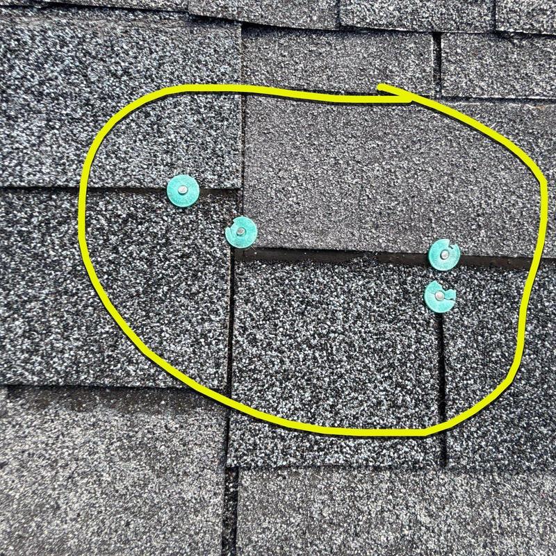 Asphalt shingles with hail damage marked in yellow