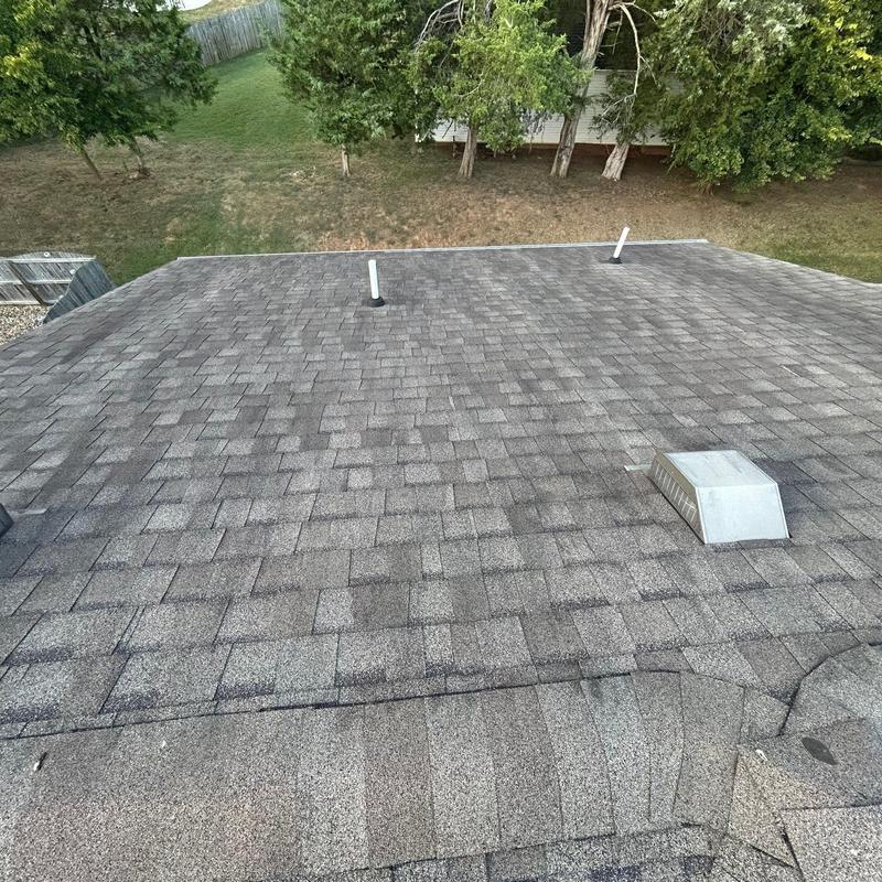 Asphalt shingle roof with vent pipes and exhaust vent