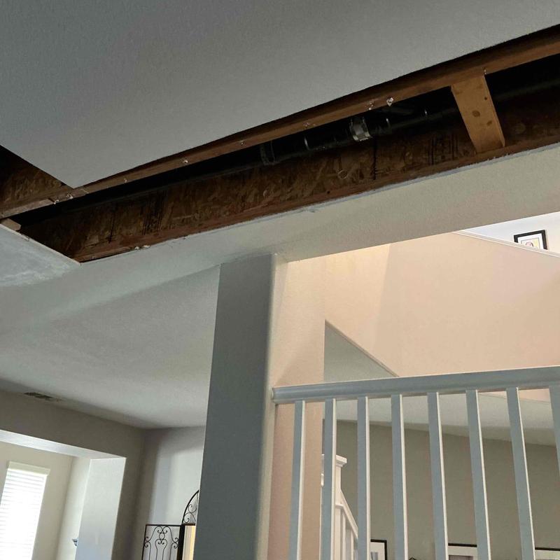 PEX piping system above ceiling joists in home