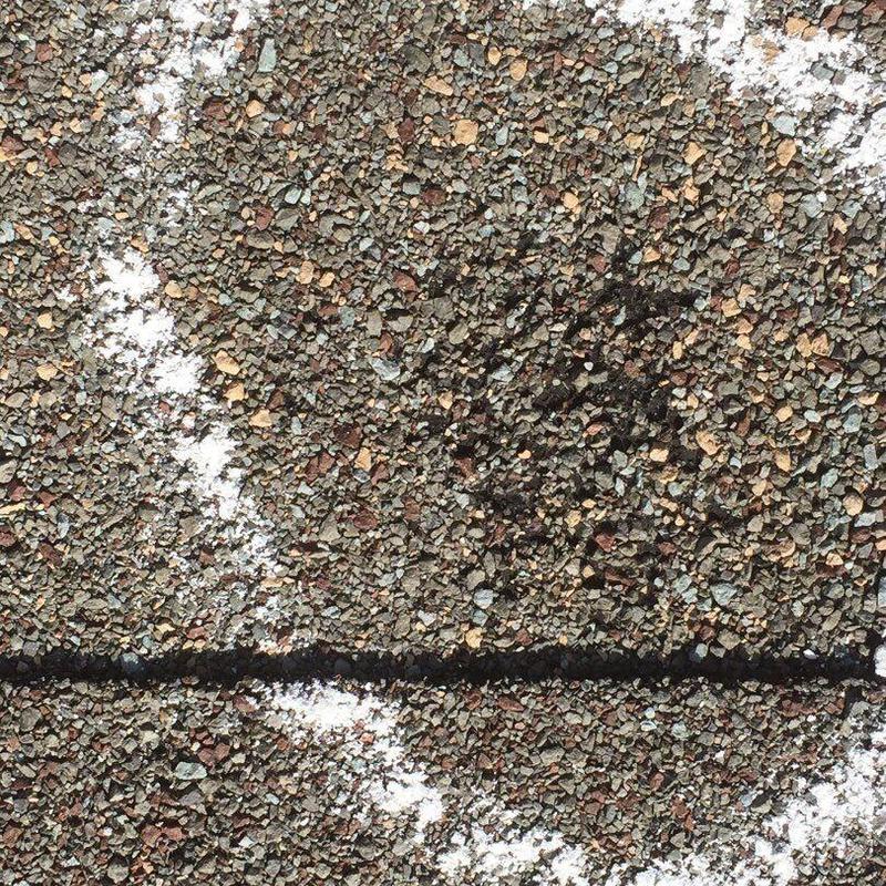 Asphalt shingle roof with hail damage marked for repair