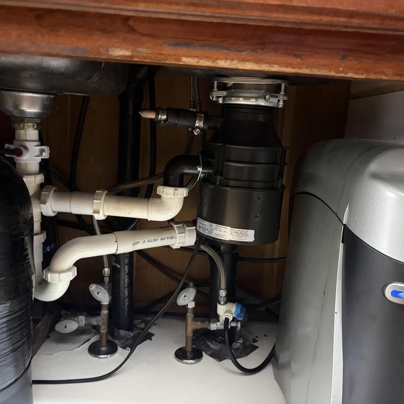 Garbage disposal drain line with capped connection